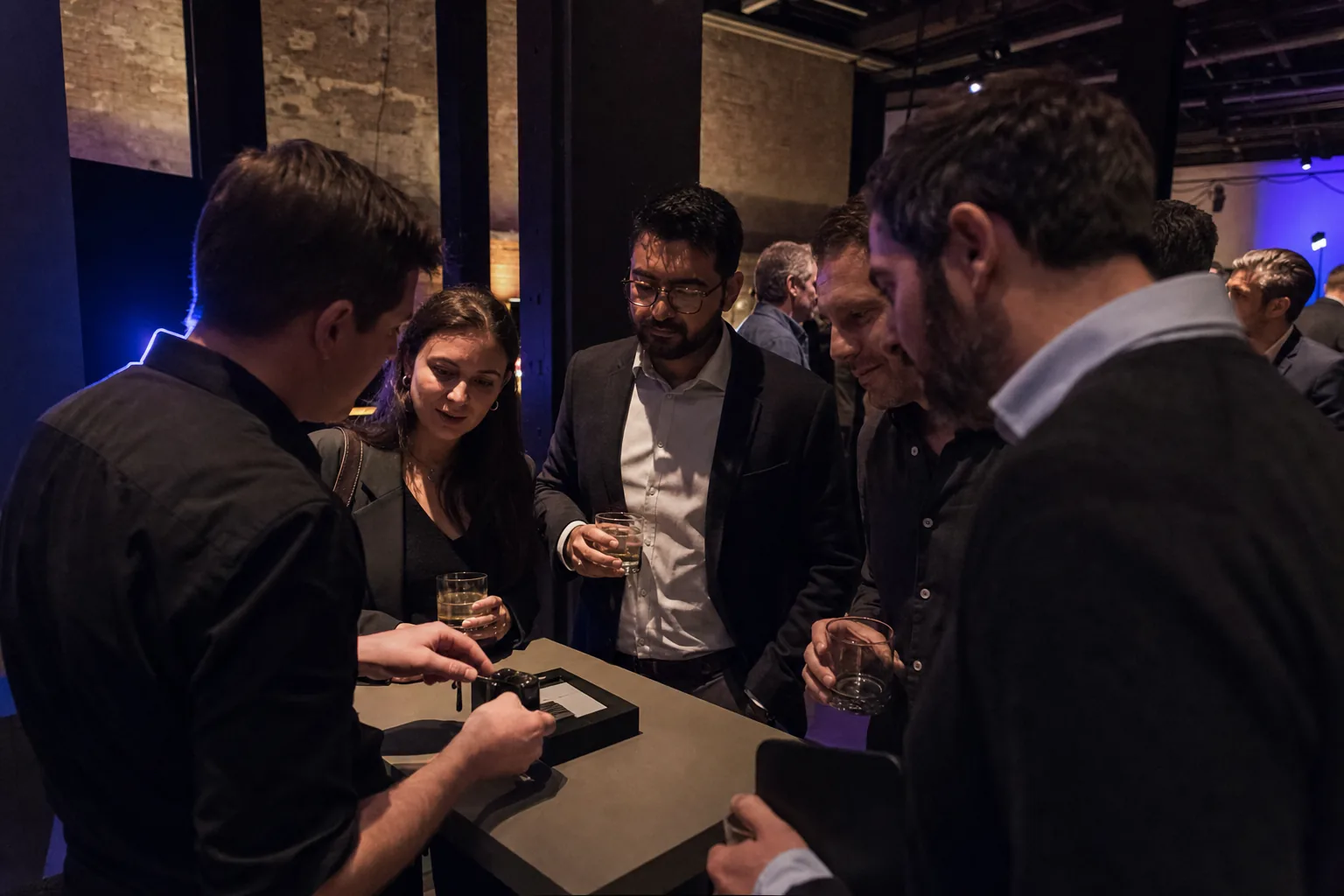 Guests gathering around a live product demonstration